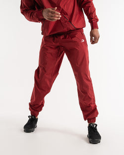 Man in a red sauna suit tracksuit with a white boxraw logo on the chest as well as adjustable wrist straps and made from polyester.